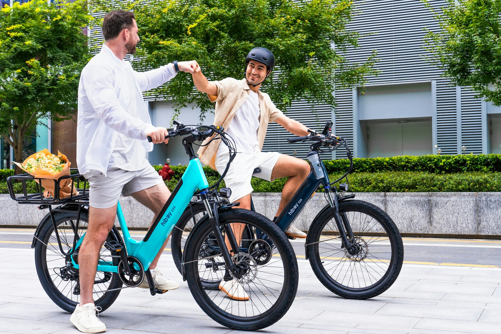 Two men riding electric bikes outdoors